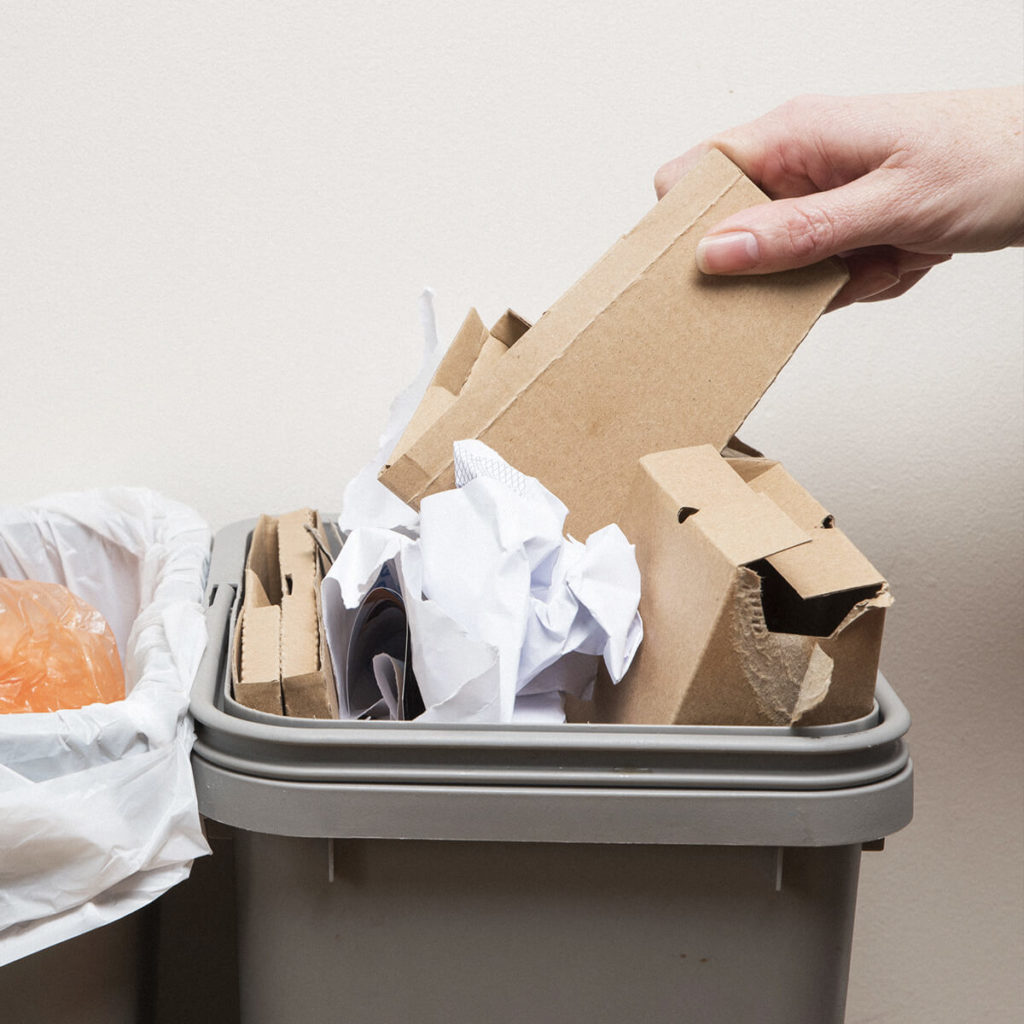 Waste bin with old cardboard in