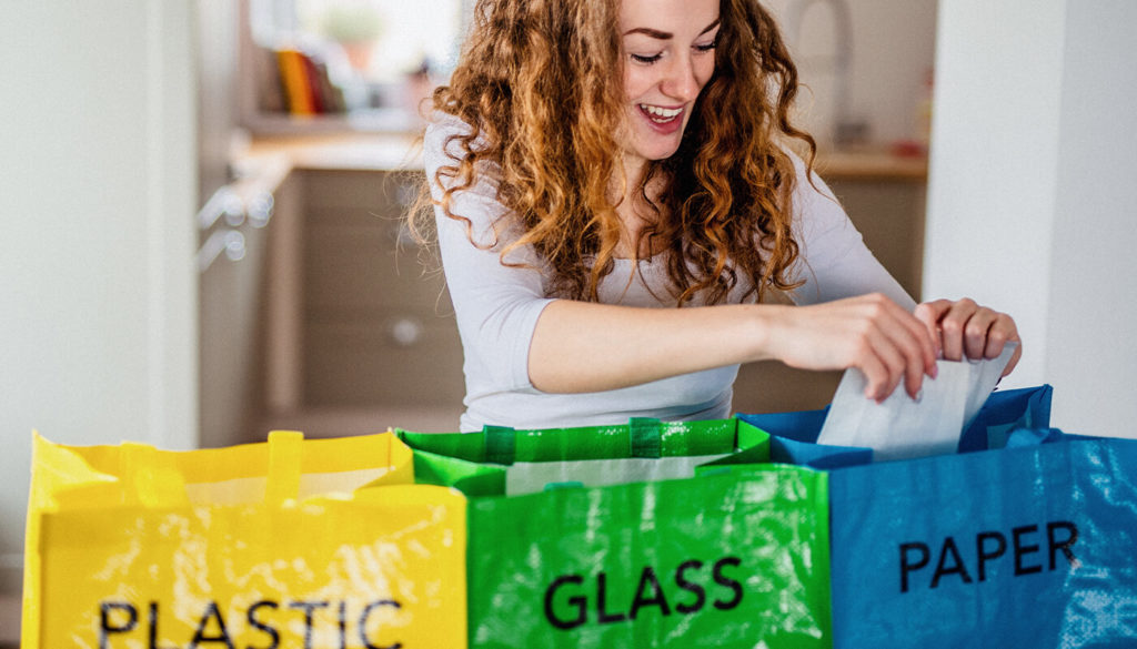 Person recycling in bags for life