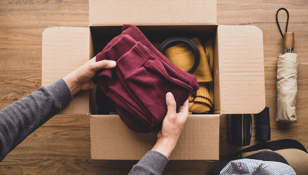 Person sharing clothes in a box