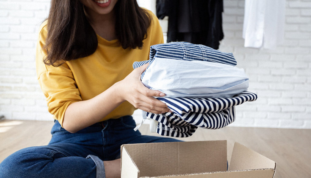 Person sharing clothes in a box