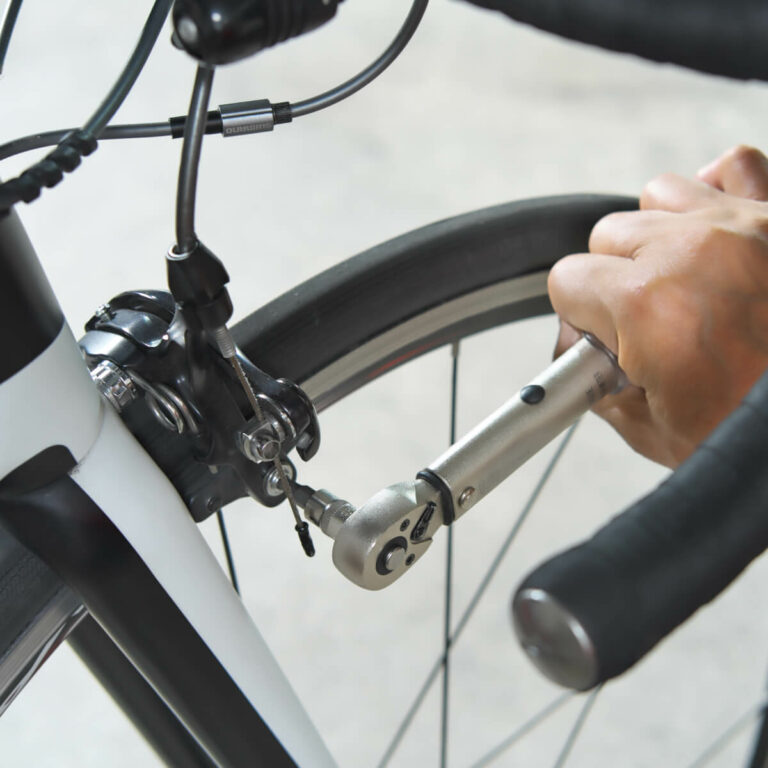 Person using bicycle torque wrench